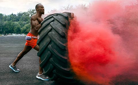 a person working out, using a tire
