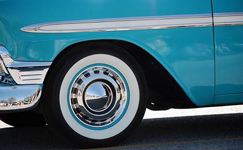 a whitewall tire mounted on a vintage car