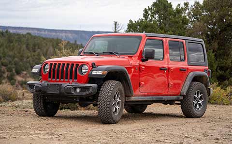 a red jeep with flotation tires
